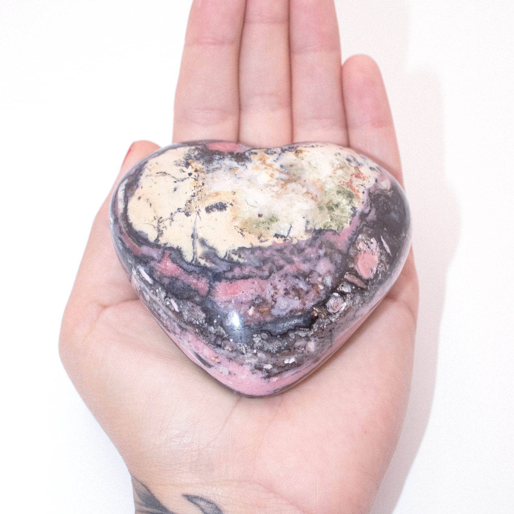 AAA Strawberry Opal heart on display with intricate details