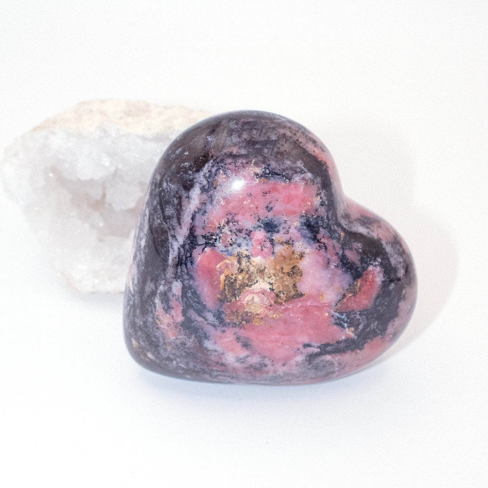 AAA Strawberry Opal heart on display with intricate details