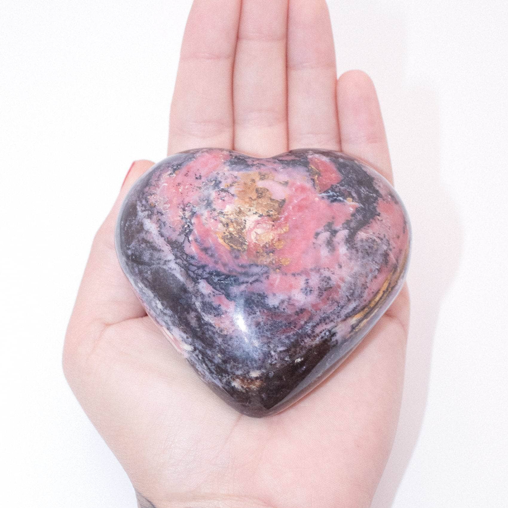AAA Strawberry Opal heart on display with intricate details