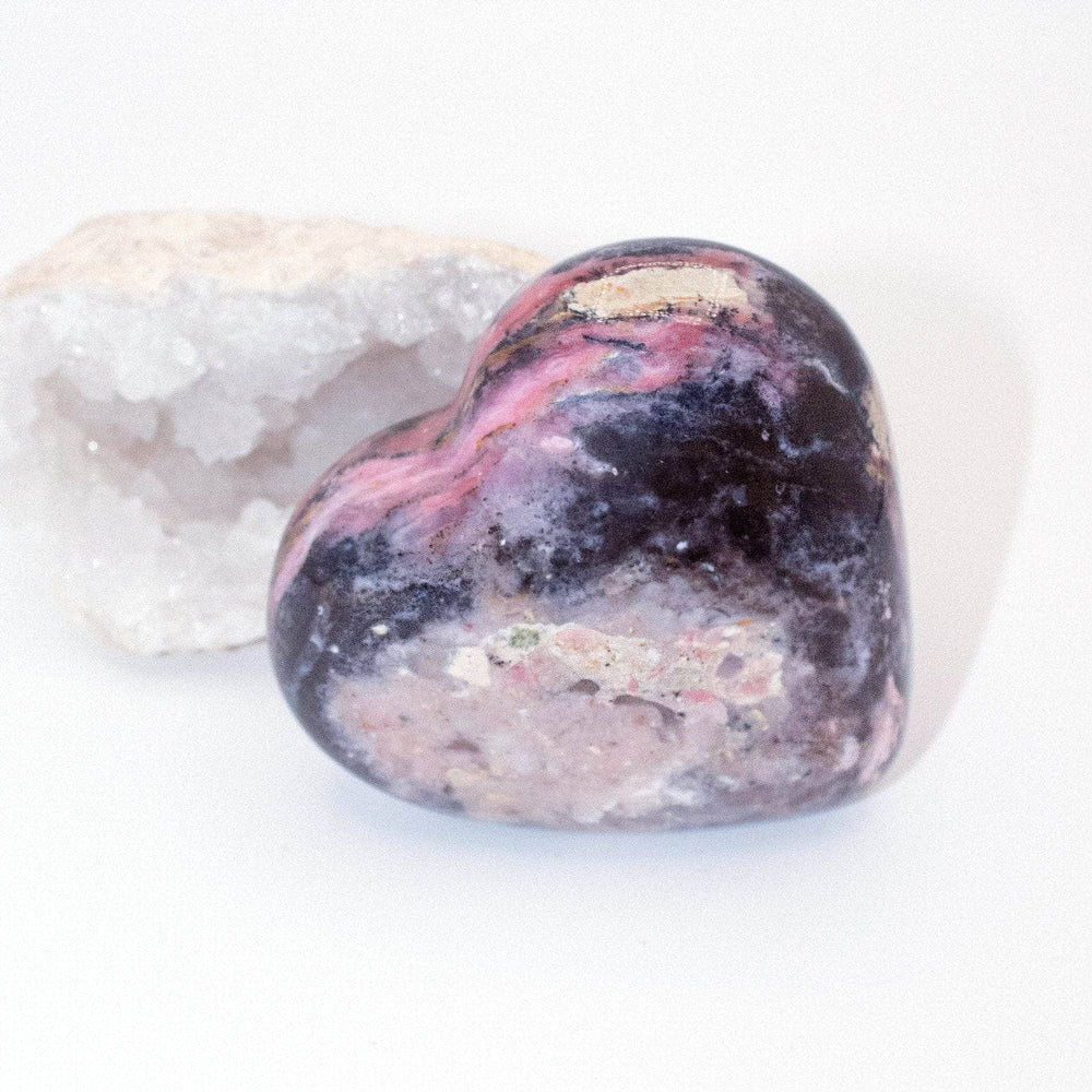 AAA Strawberry Opal heart on display with intricate details