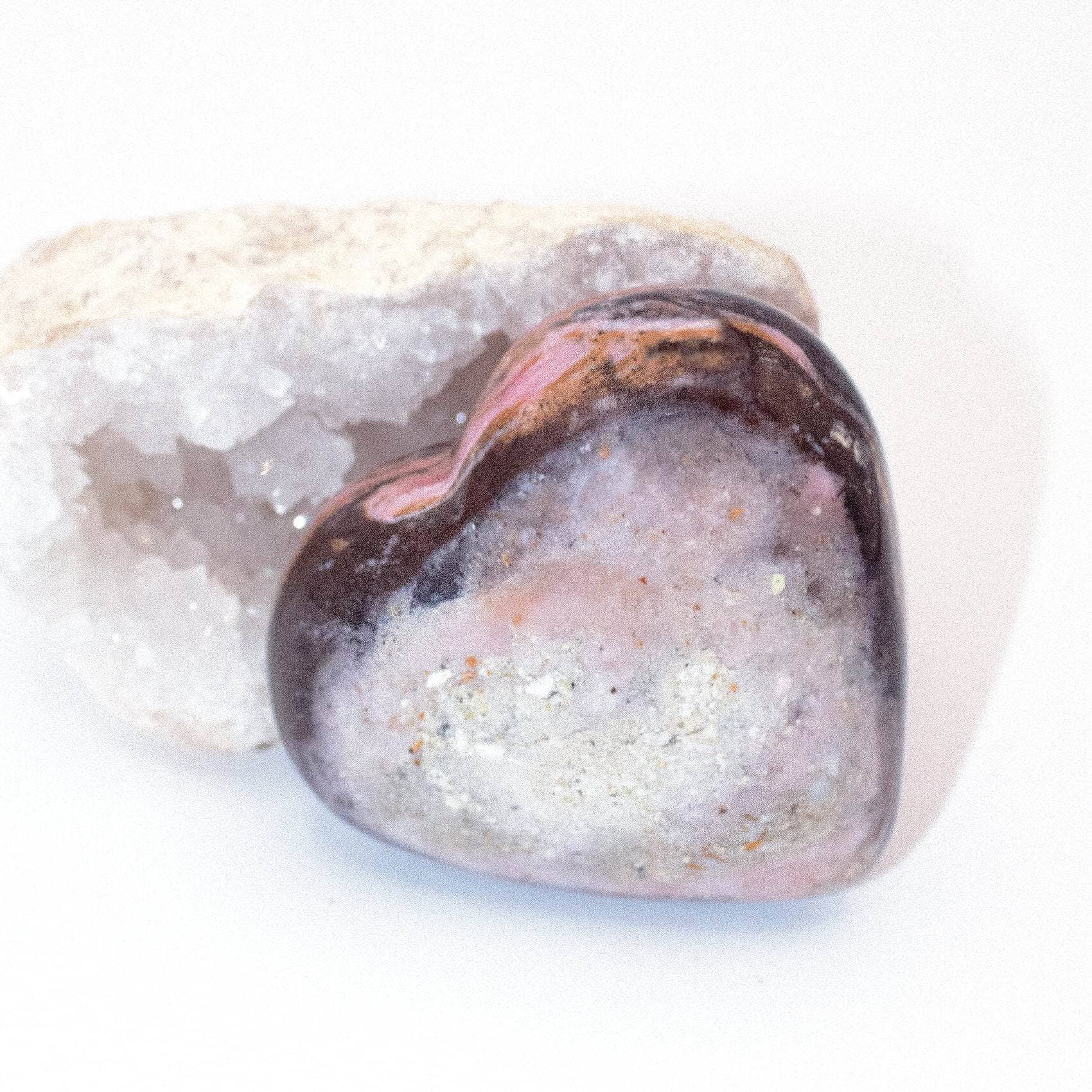 AAA Strawberry Opal heart on display with intricate details