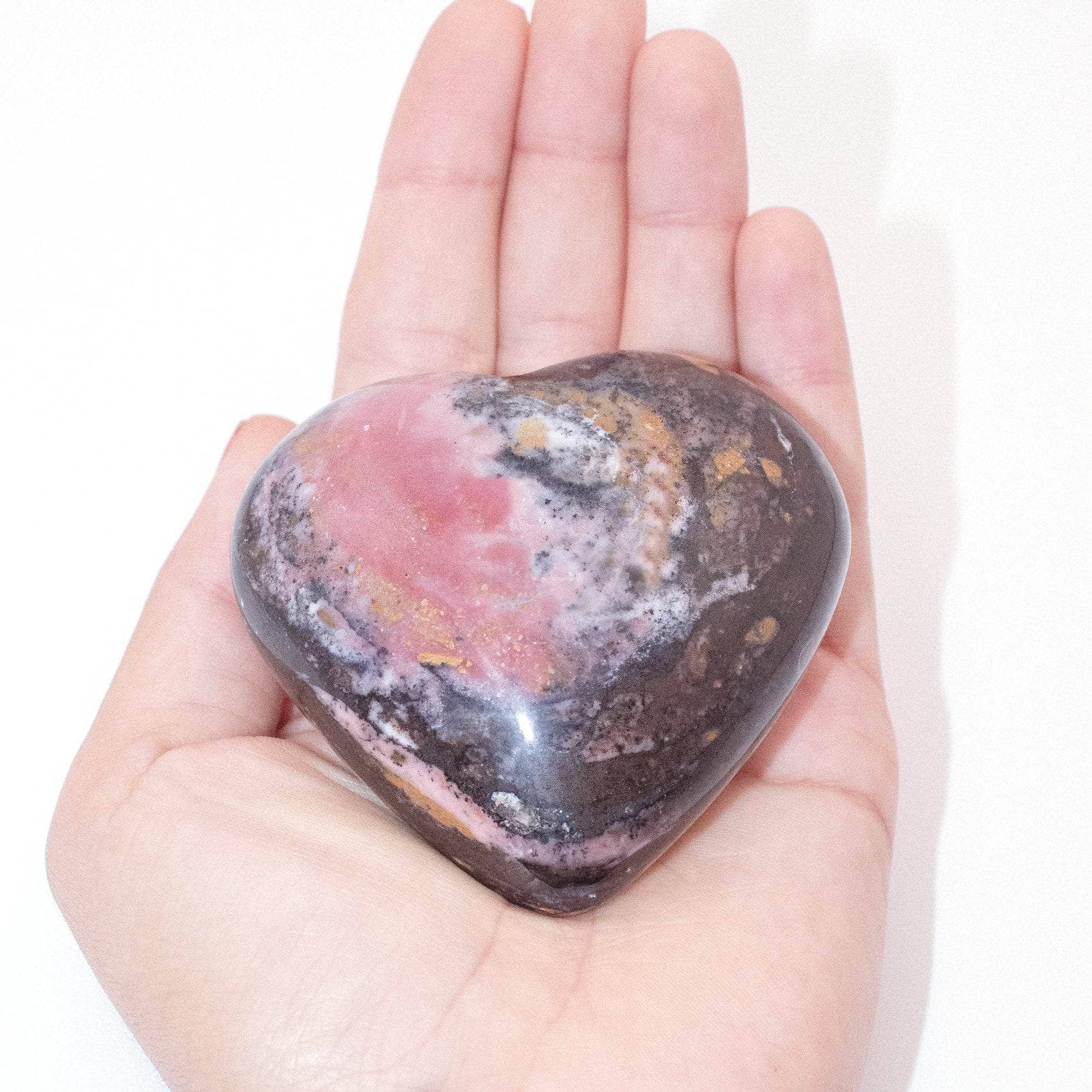 AAA Strawberry Opal heart on display with intricate details