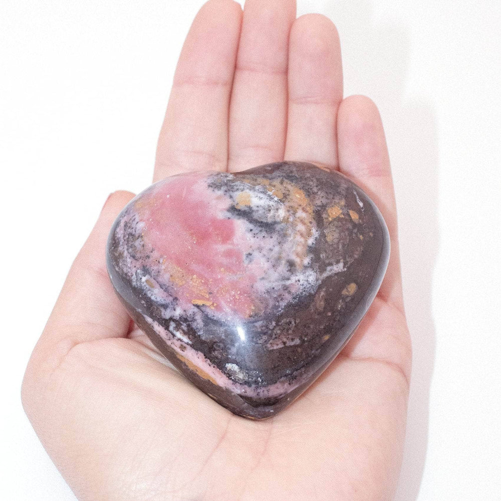 AAA Strawberry Opal heart on display with intricate details