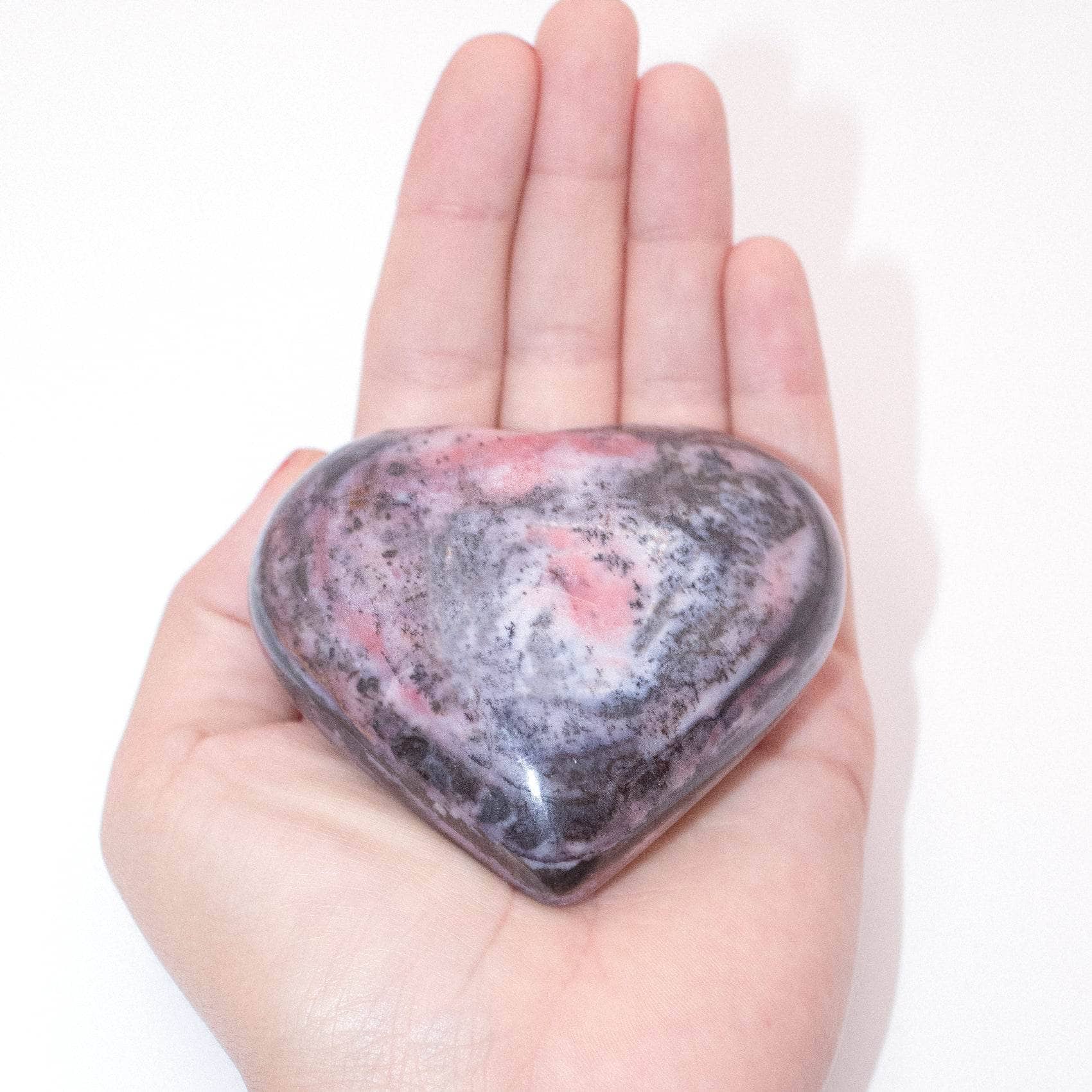 AAA Strawberry Opal heart on display with intricate details