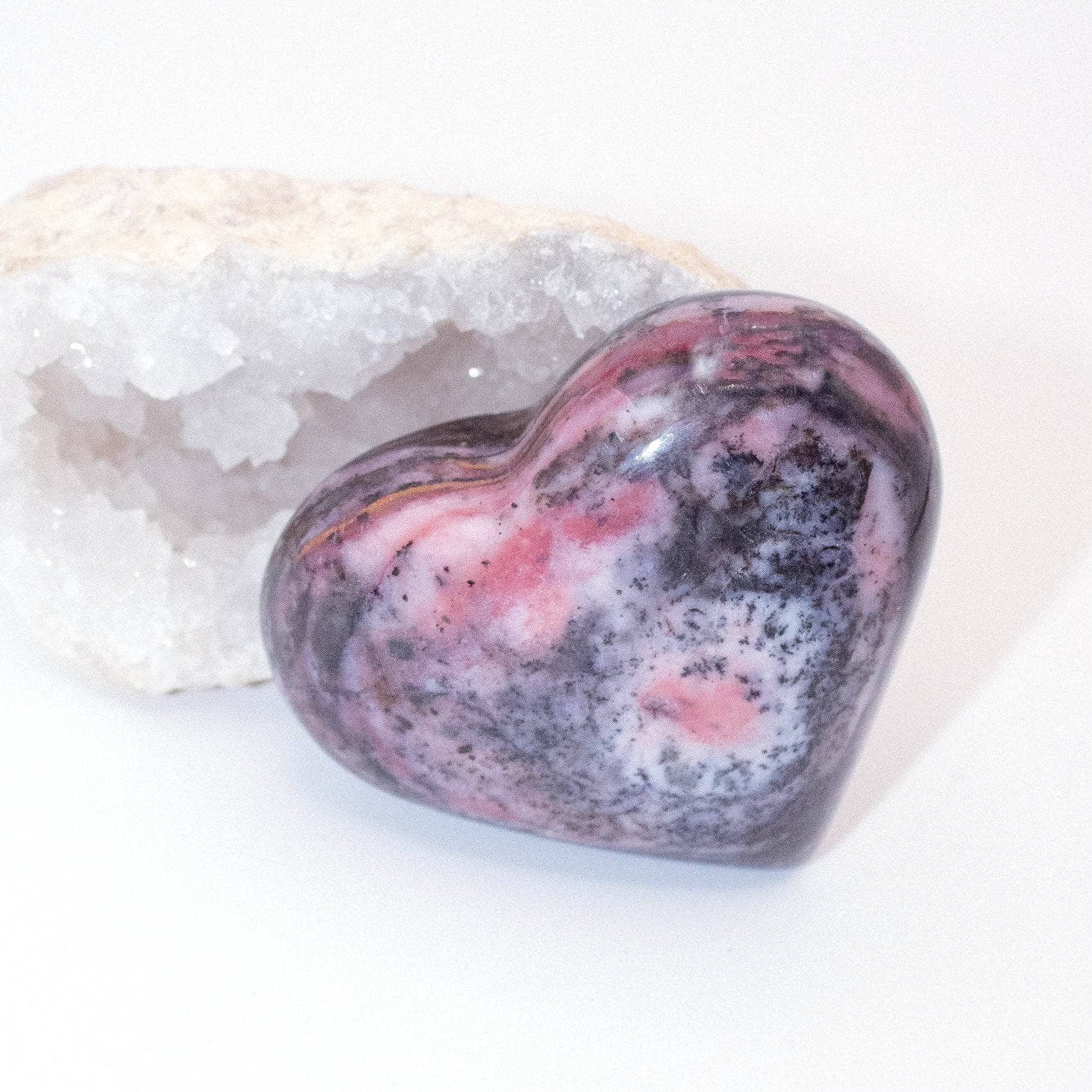 AAA Strawberry Opal heart on display with intricate details