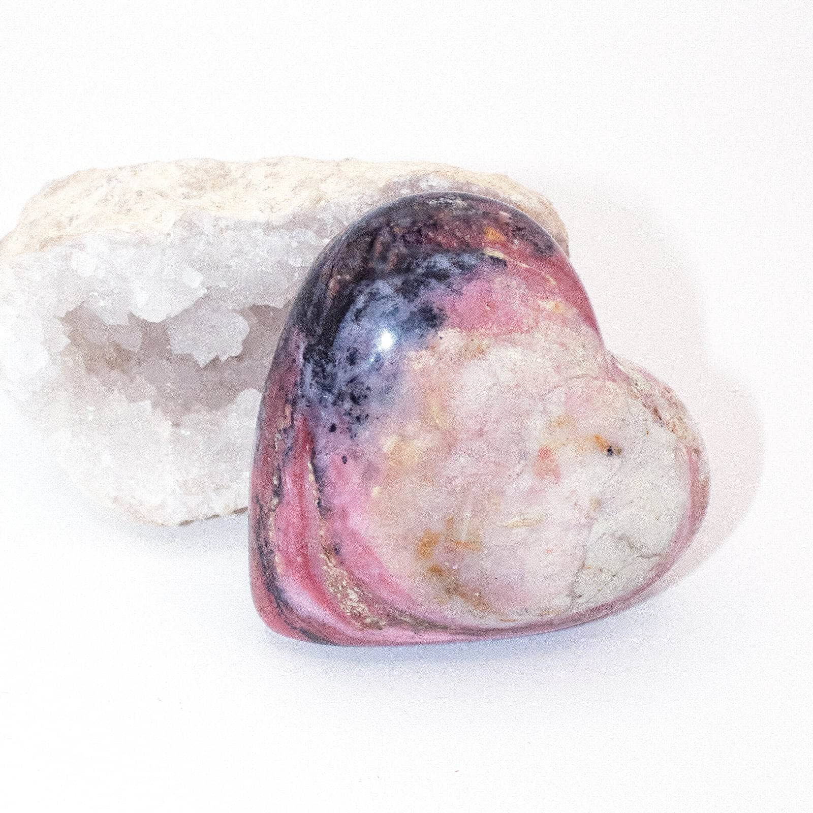 AAA Strawberry Opal heart on display with intricate details