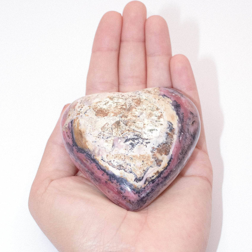 AAA Strawberry Opal heart on display with intricate details