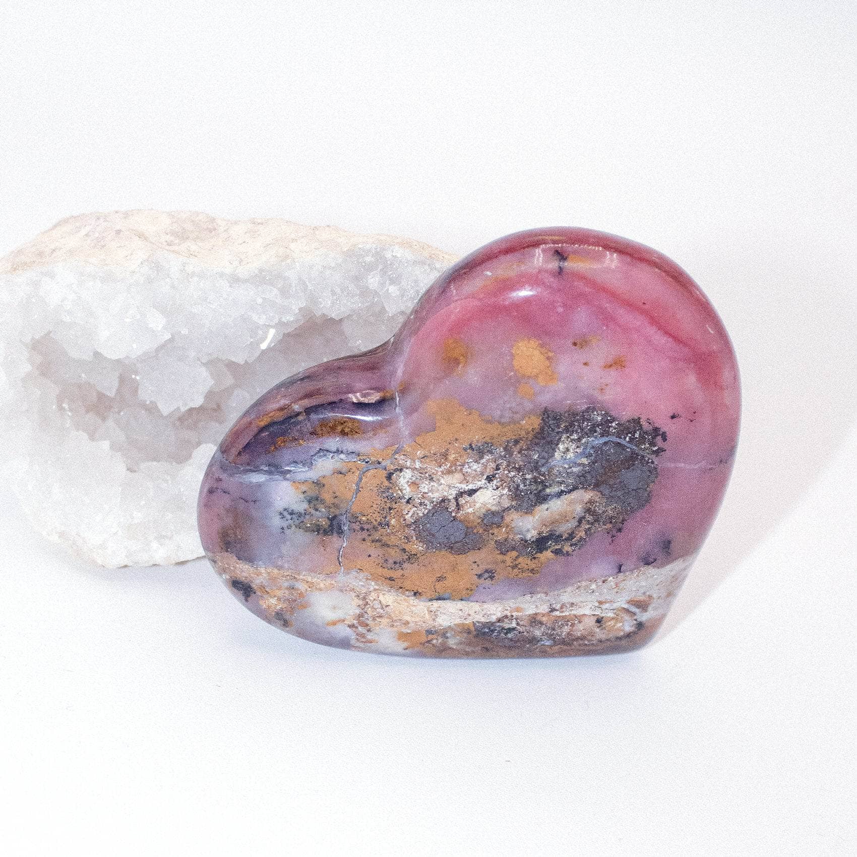 AAA Strawberry Opal heart on display with intricate details