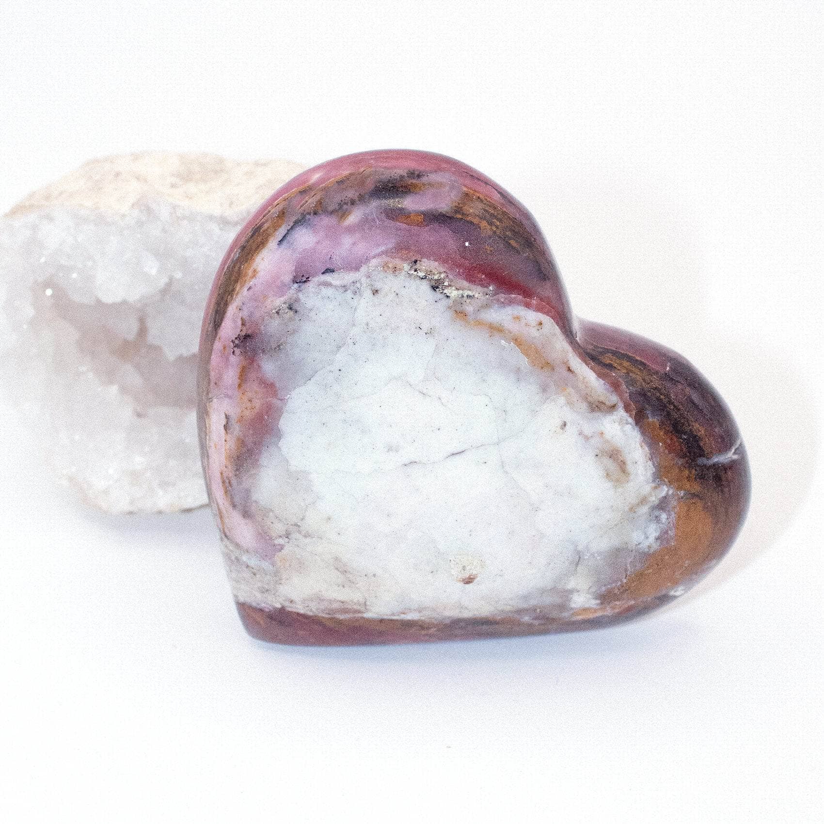 AAA Strawberry Opal heart on display with intricate details
