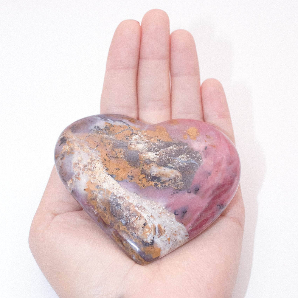 AAA Strawberry Opal heart on display with intricate details
