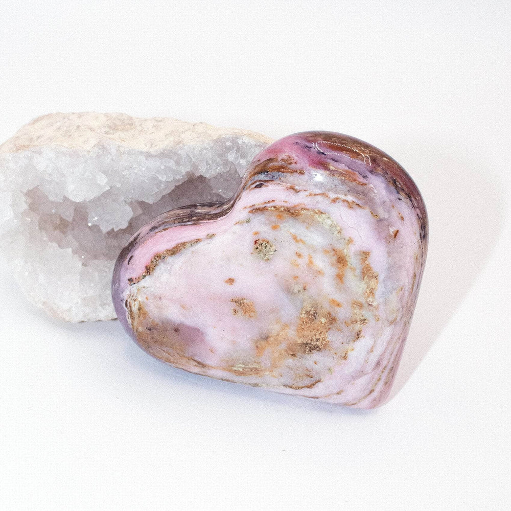 AAA Strawberry Opal heart on display with intricate details