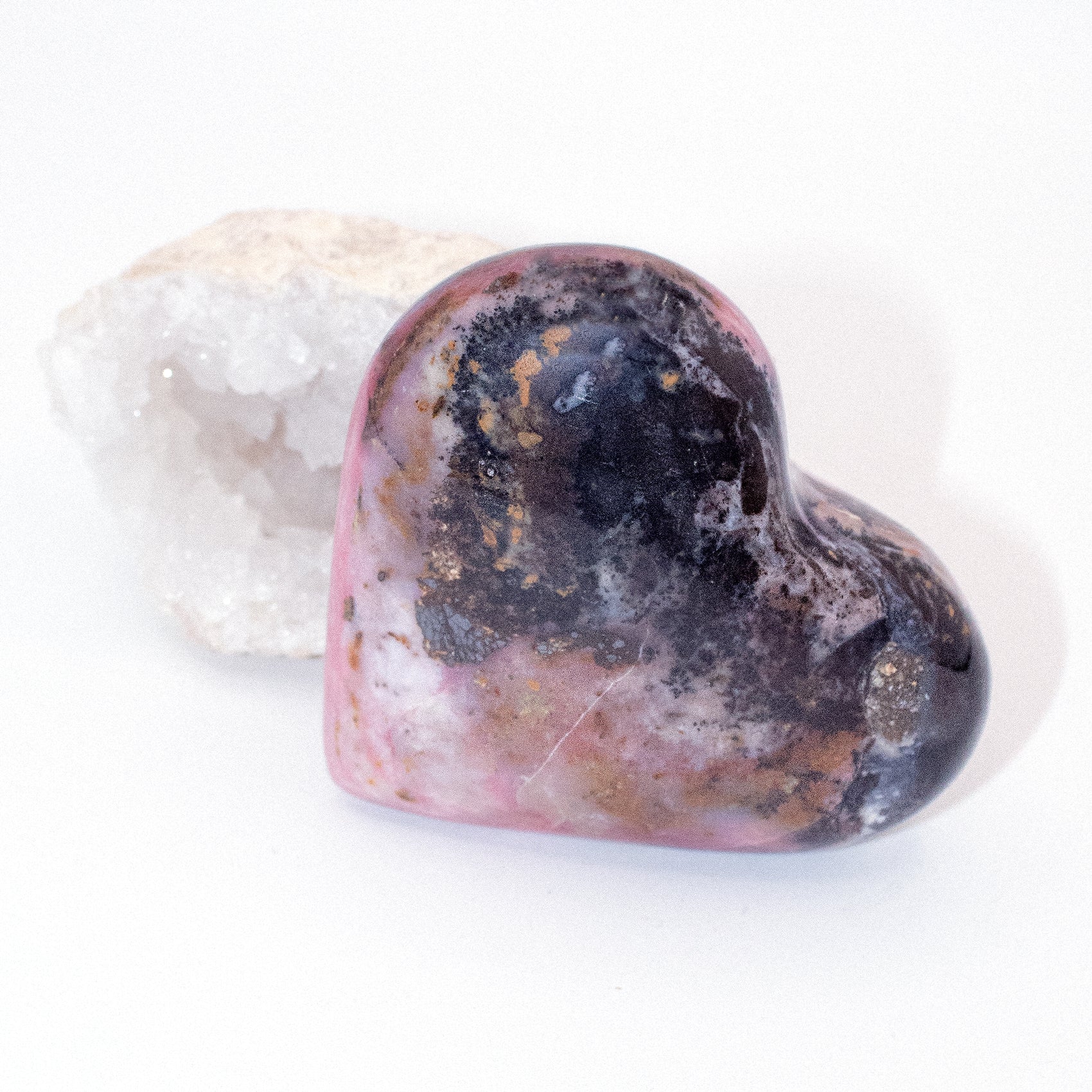 AAA Strawberry Opal heart on display with intricate details