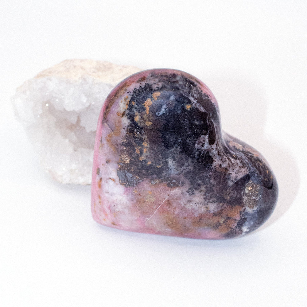 AAA Strawberry Opal heart on display with intricate details
