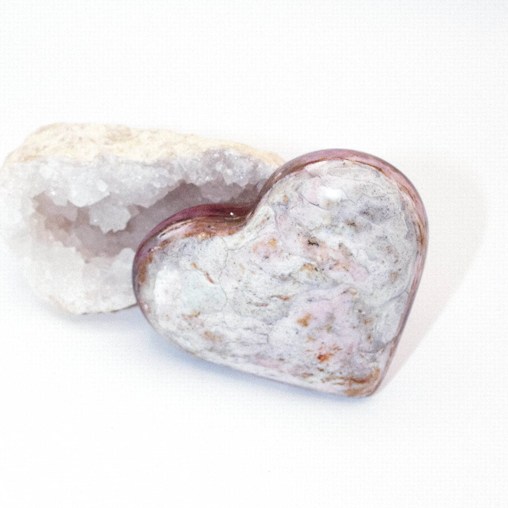 AAA Strawberry Opal heart on display with intricate details