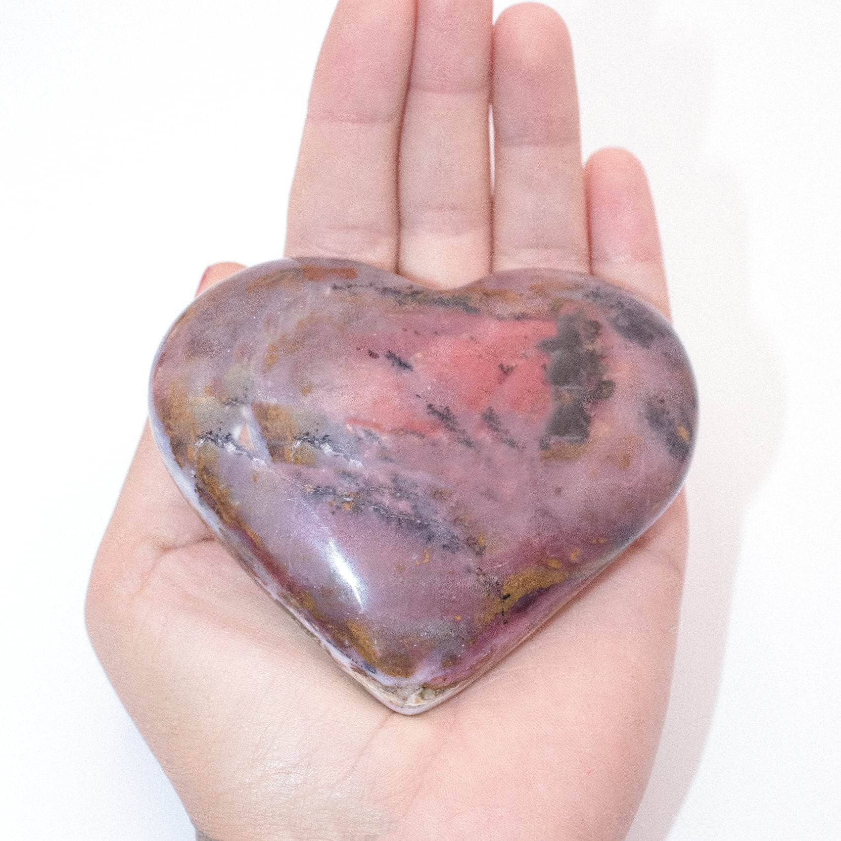 AAA Strawberry Opal heart on display with intricate details
