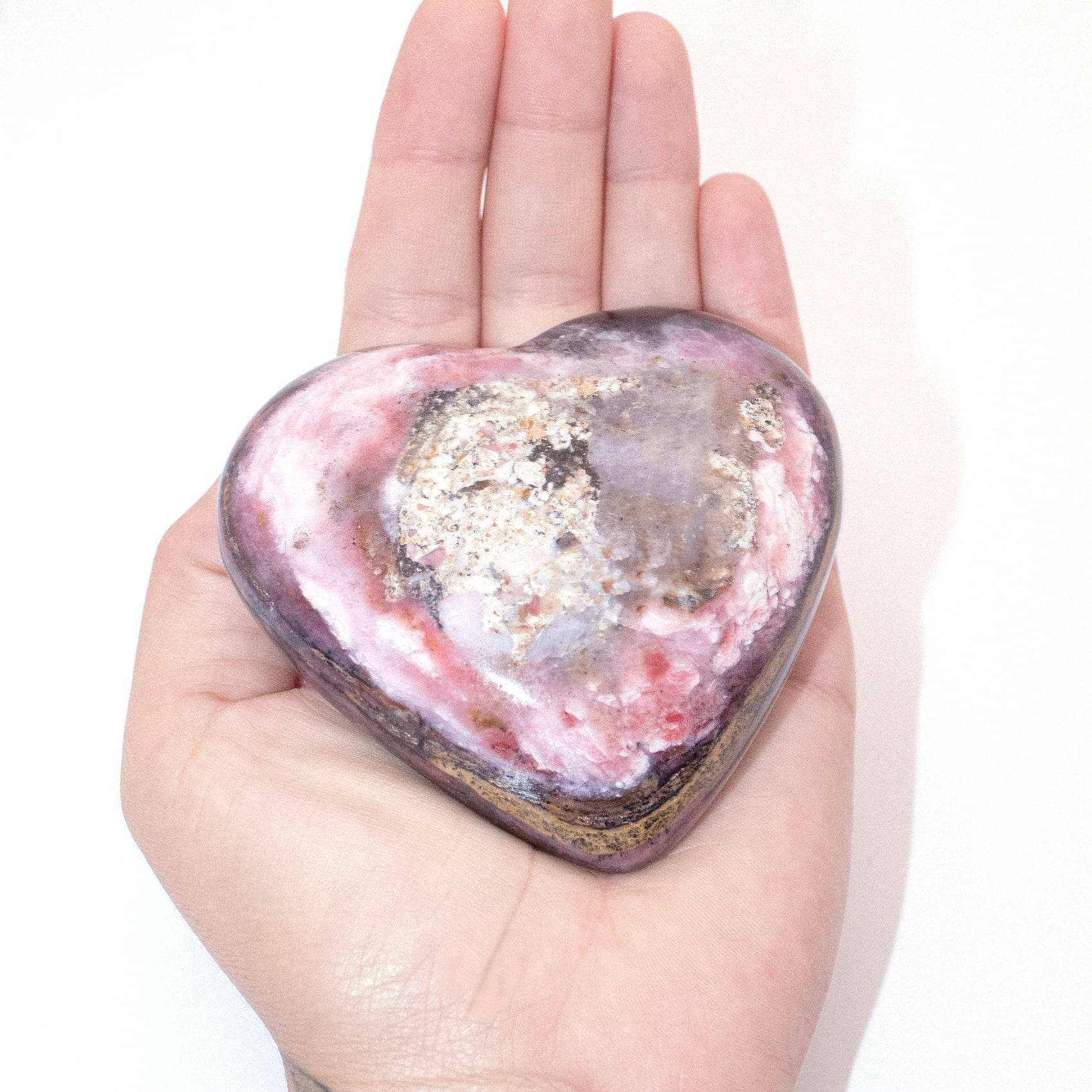 AAA Strawberry Opal heart on display with intricate details