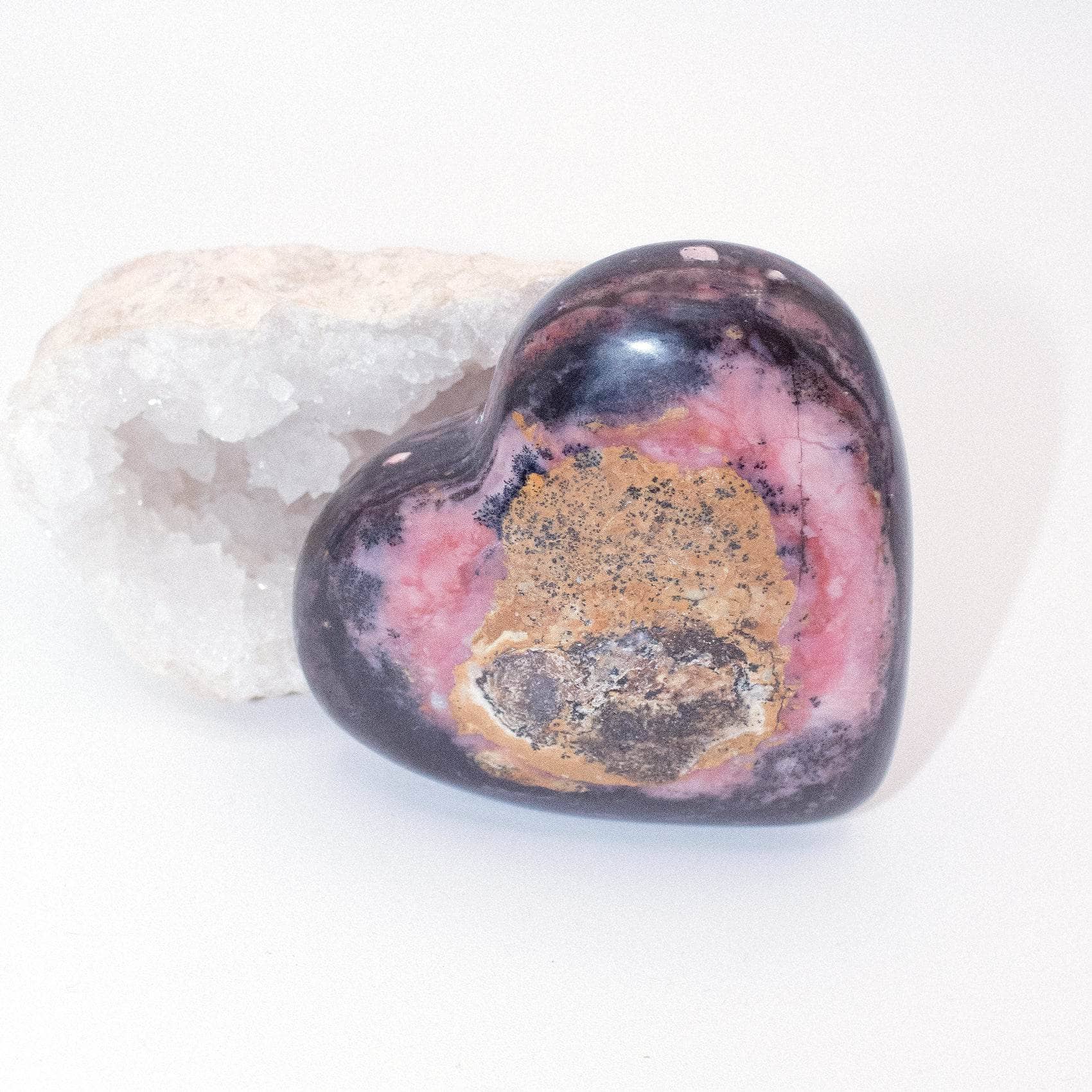 AAA Strawberry Opal heart on display with intricate details