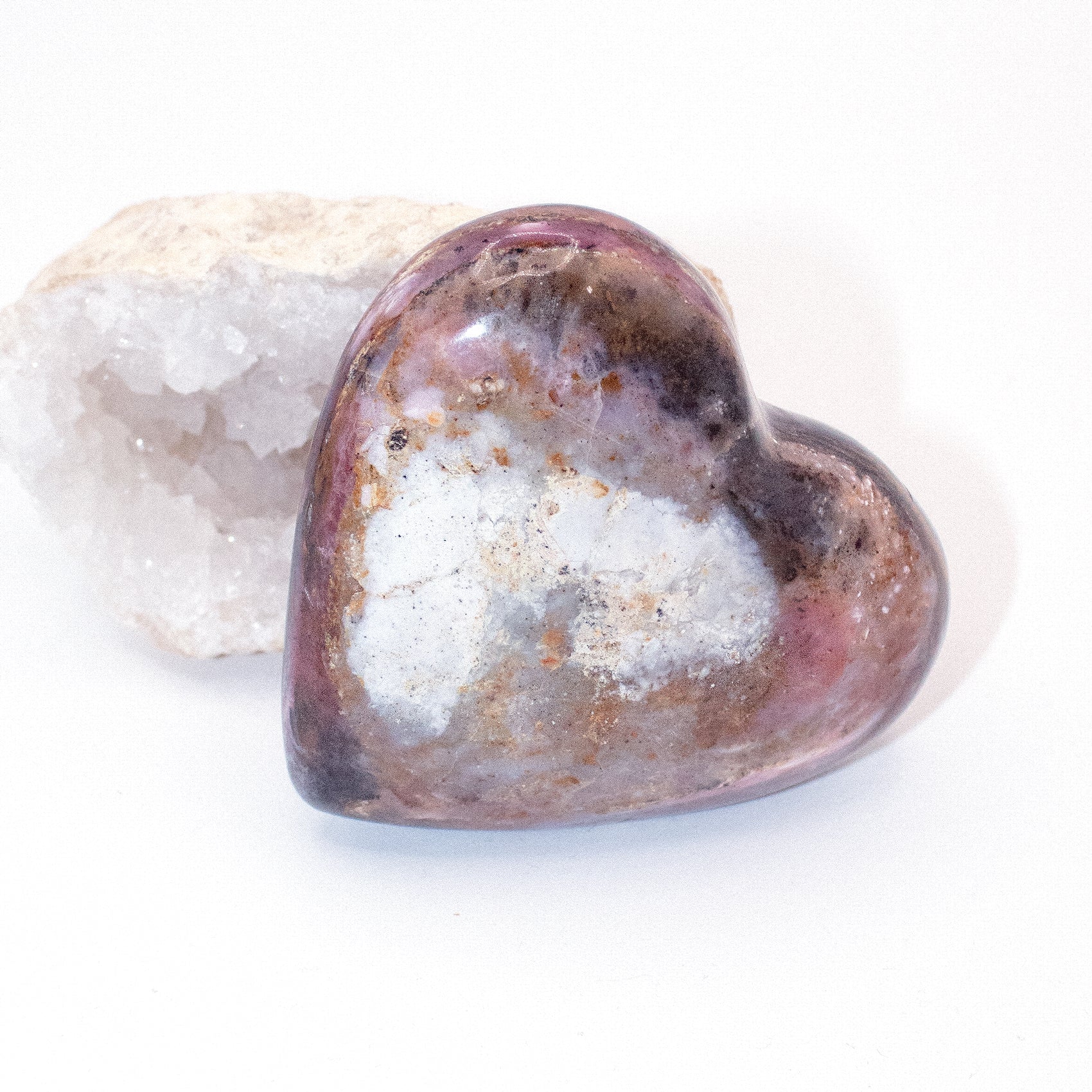 AAA Strawberry Opal heart on display with intricate details