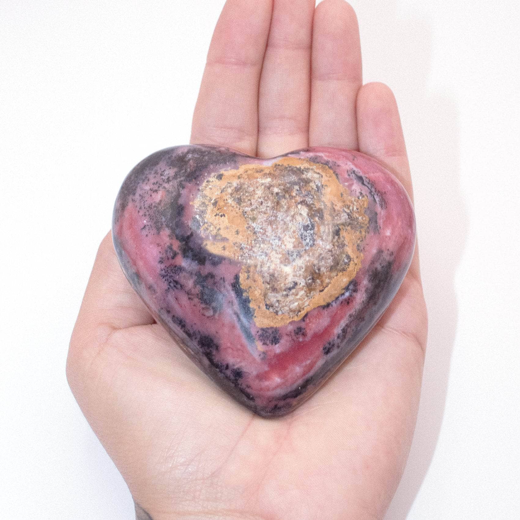 AAA Strawberry Opal heart on display with intricate details