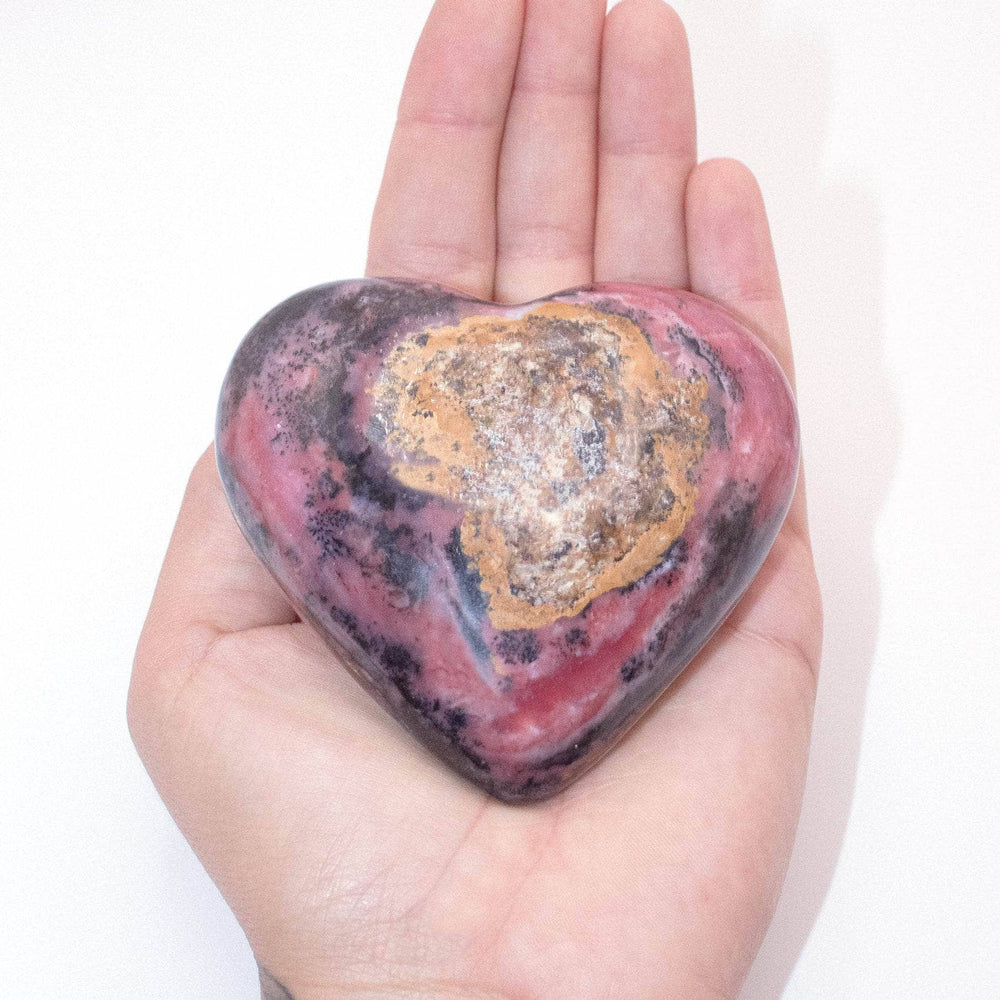 AAA Strawberry Opal heart on display with intricate details