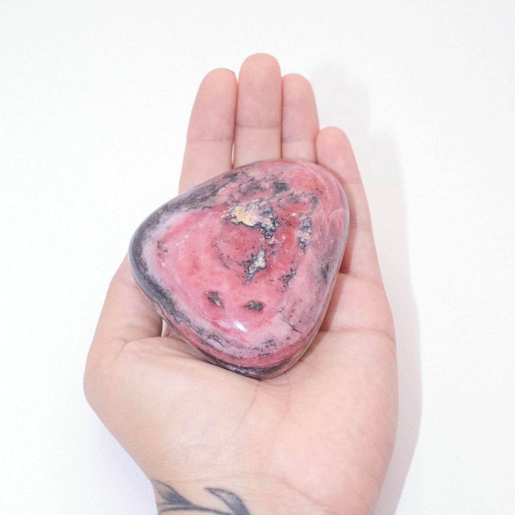 AAA Strawberry Opal palm stone on display with stunning details