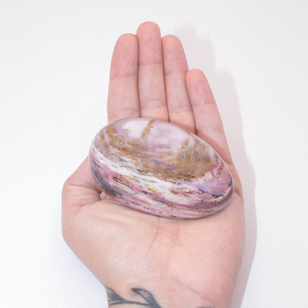AAA Strawberry Opal palm stone on display with stunning details