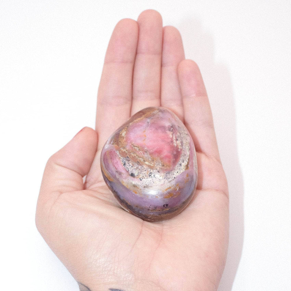 Close-up of Strawberry Opal palm stone showing natural color patterns
