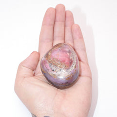 Close-up of Strawberry Opal palm stone showing natural color patterns