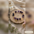 Natural amethyst crystal bracelet on white background, hand-strung 8mm Brazilian amethyst beads for wealth and spiritual calm, Crystalvana