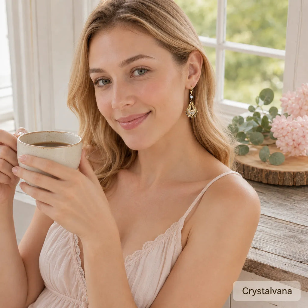 French design hollow water drop earrings flat lay on wood slice with eucalyptus and pink carnation, Crystalvana