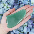 Green Aventurine gua sha tool held in the hand