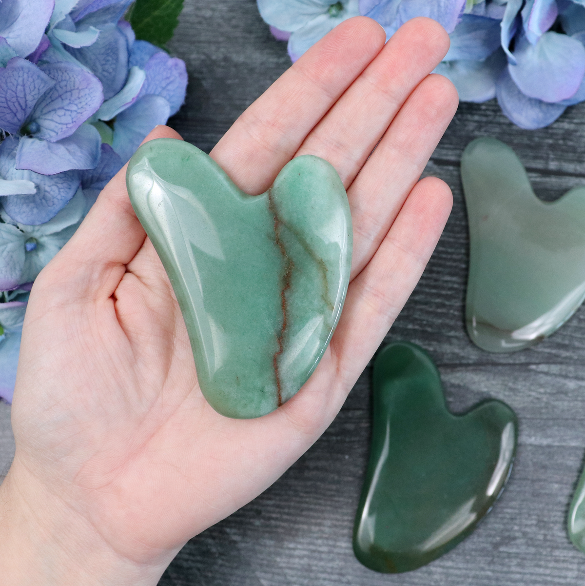 Green Aventurine gua sha tool in its Crystalvana storage pouch