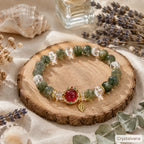 Green phantom quartz abundance bracelet worn on wrist with white dress on stairs, model lifestyle shot, Crystalvana