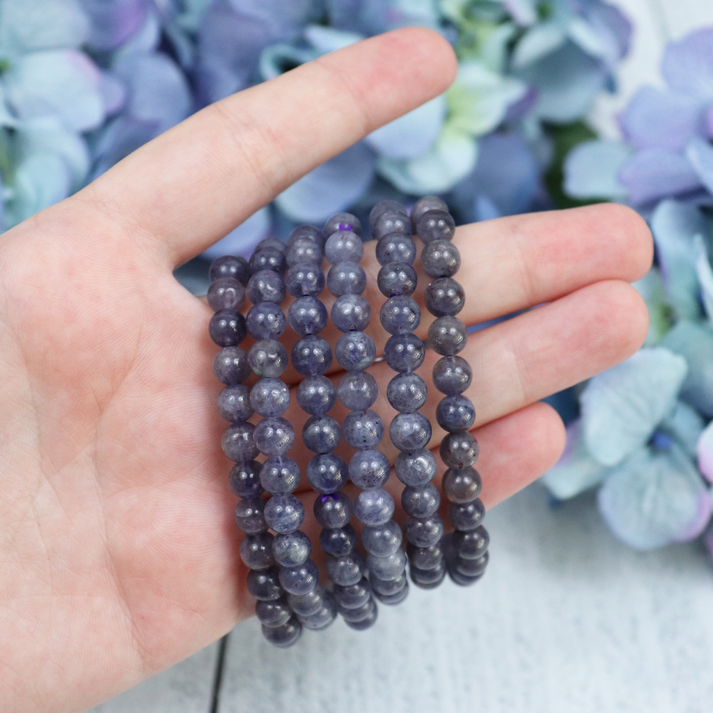 Iolite crystal bracelet stacked with other Crystalvana pieces