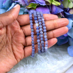 Iolite crystal bracelet stacked with other Crystalvana pieces
