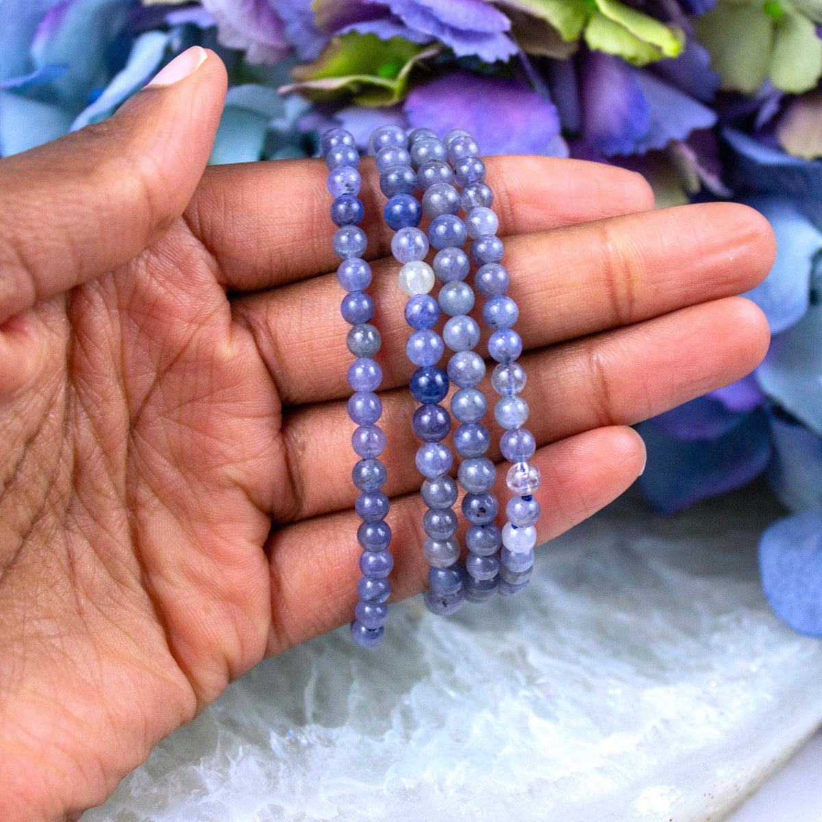 Iolite crystal bracelet stacked with other Crystalvana pieces