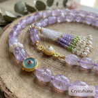Evil eye charm close-up on lavender amethyst tassel necklace protective detail, Crystalvana