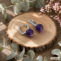 Natural amethyst S925 silver dangle earrings close-up on branch nature background, Crystalvana