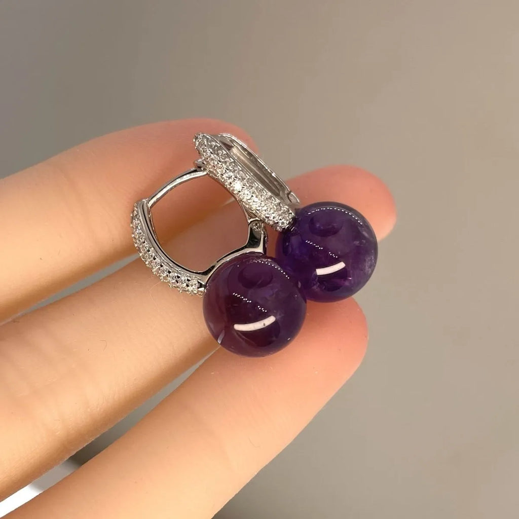 Amethyst S925 silver dangle earrings flat lay on wood slice with flowers, Crystalvana