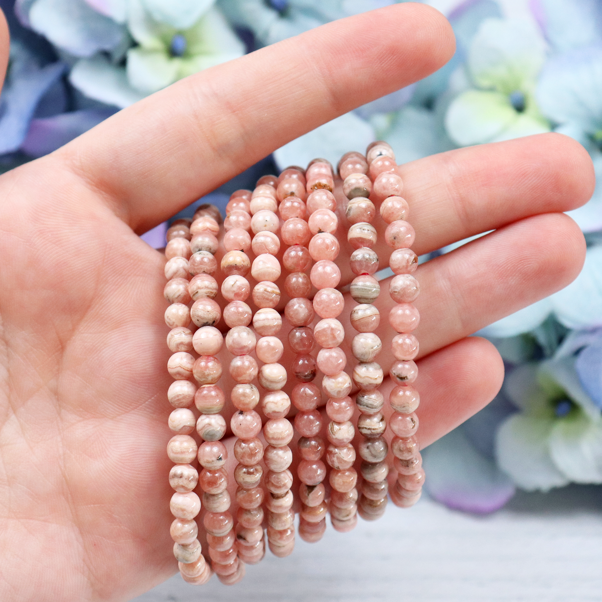 Close-up of natural Rhodochrosite beads showing colour and pattern