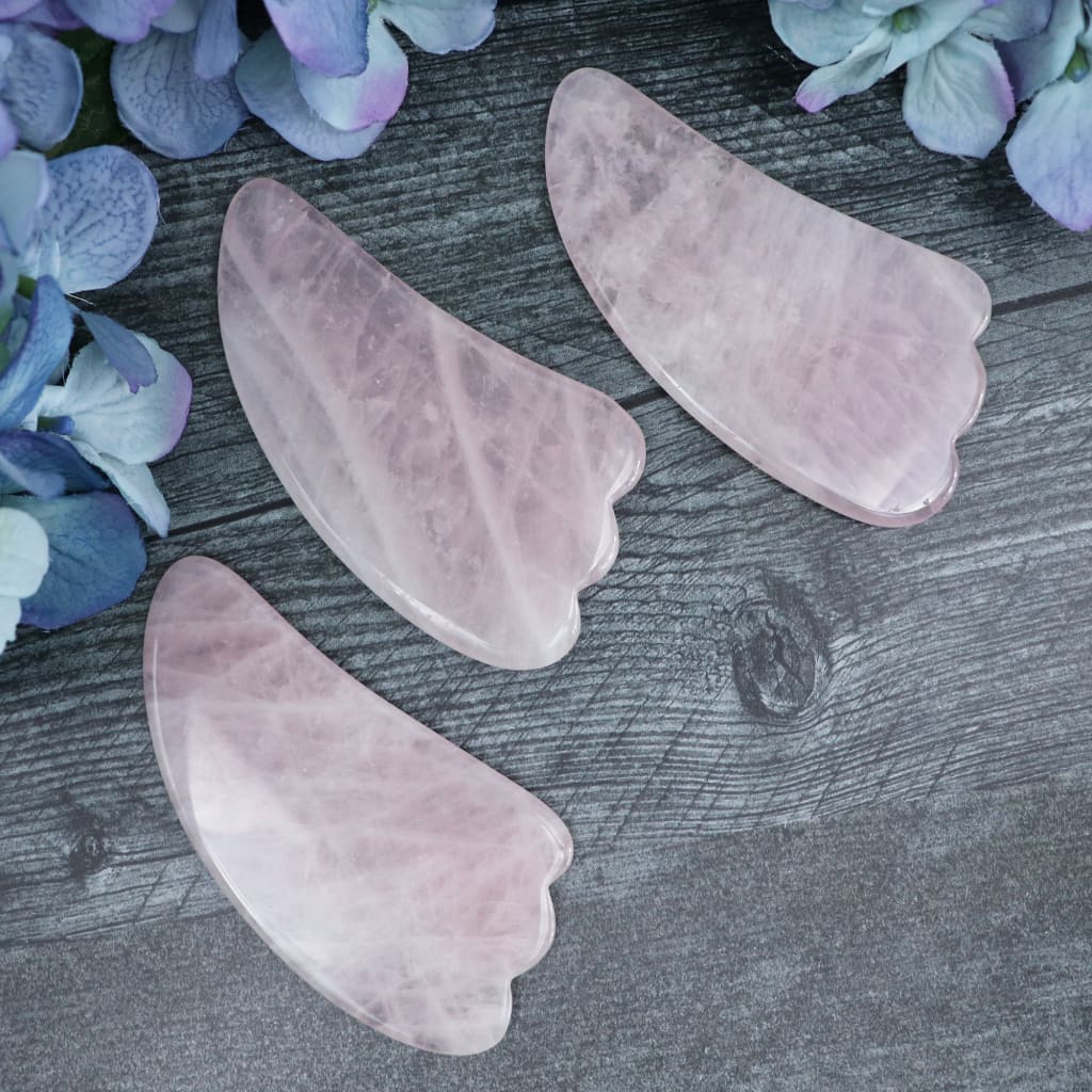 Rose Quartz gua sha tool held in the hand