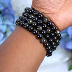 Close-up of natural Gold Sheen Obsidian beads showing colour and pattern