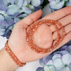 Close-up of natural Sunstone beads showing colour and pattern