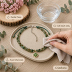 Green agate choker flat lay on wood slice showing 4-leaf clover pendant detail, Crystalvana