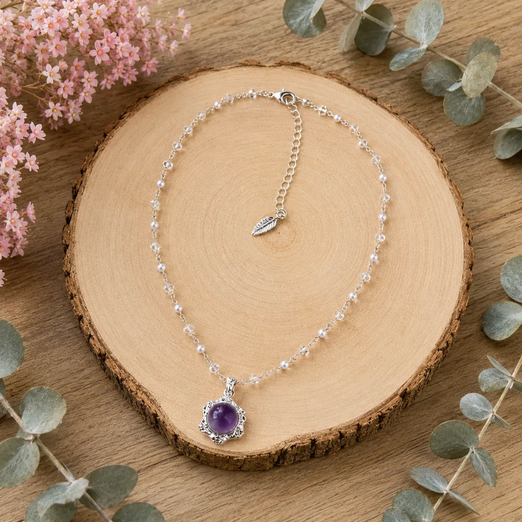 Model smiling wearing amethyst pendant necklace hand on hair, Crystalvana